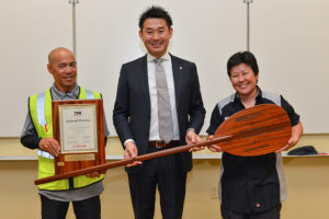 Satoshi "Scott" Watanabe of Toyota Motor Corporation, Technician Natalie Ota, and Lot Attendant Terry Oye pose for a photo with the TSM-Kodawari Certification